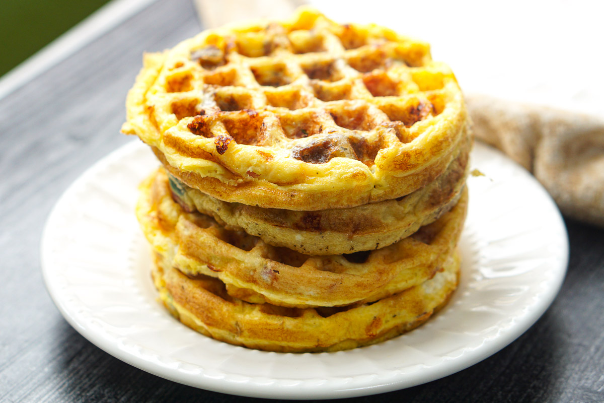 a white plate with a stack of waffle omelets