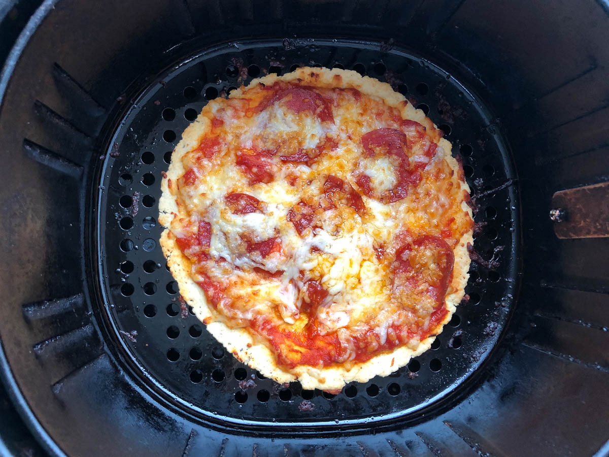 air fryer basket with finished keto pizza