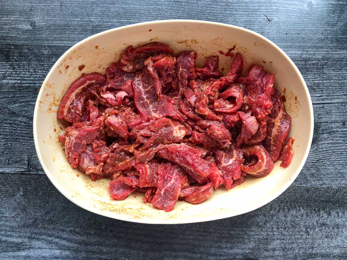 bowl with sliced marinated flank steak