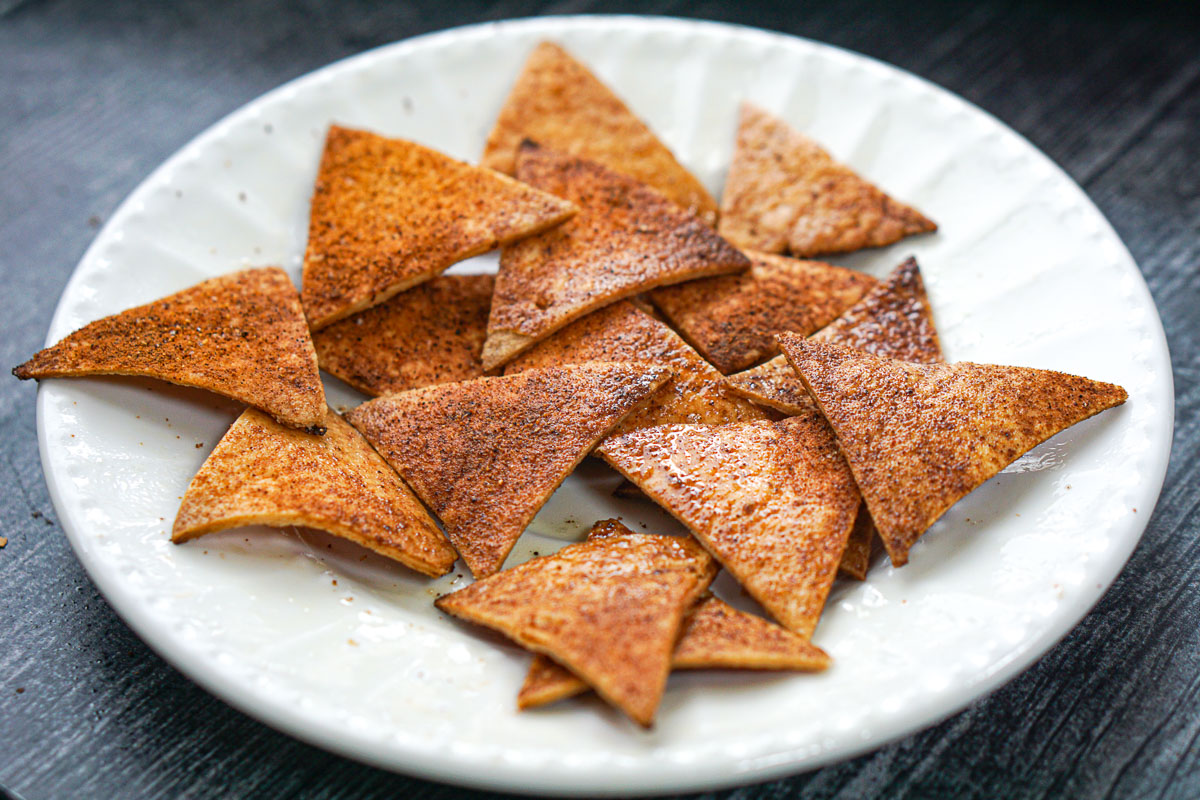 closeup of a white plate with baked low carb tortilla chips