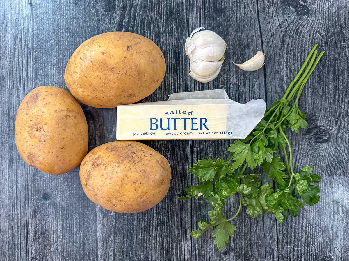 recipe ingredients - potatoes, garlic, butter and parsley