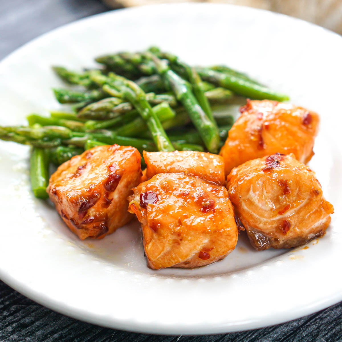 white plate with air fryer keto salmon bites and asparagus