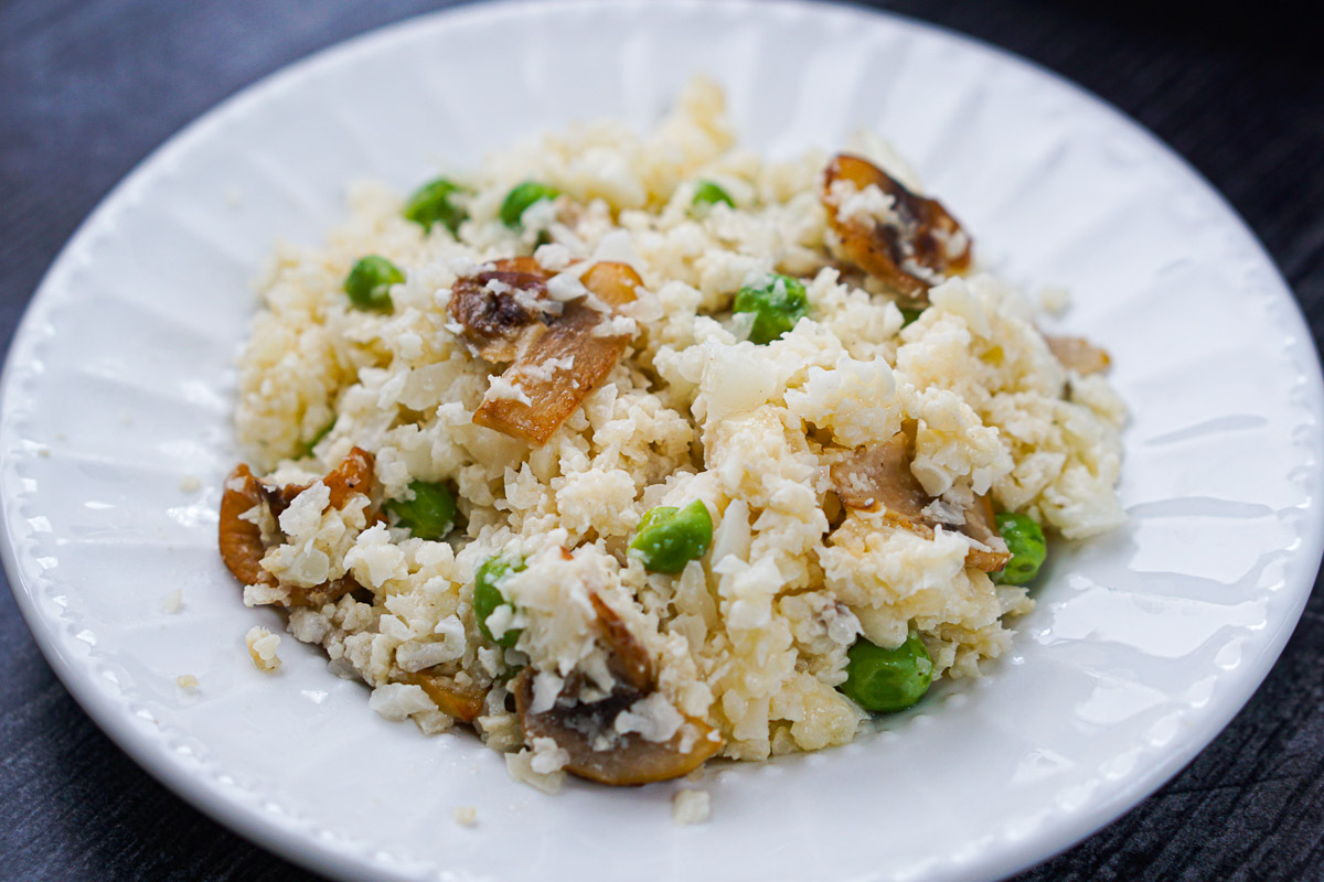 white plate with keto cauliflower risotto with mushrooms