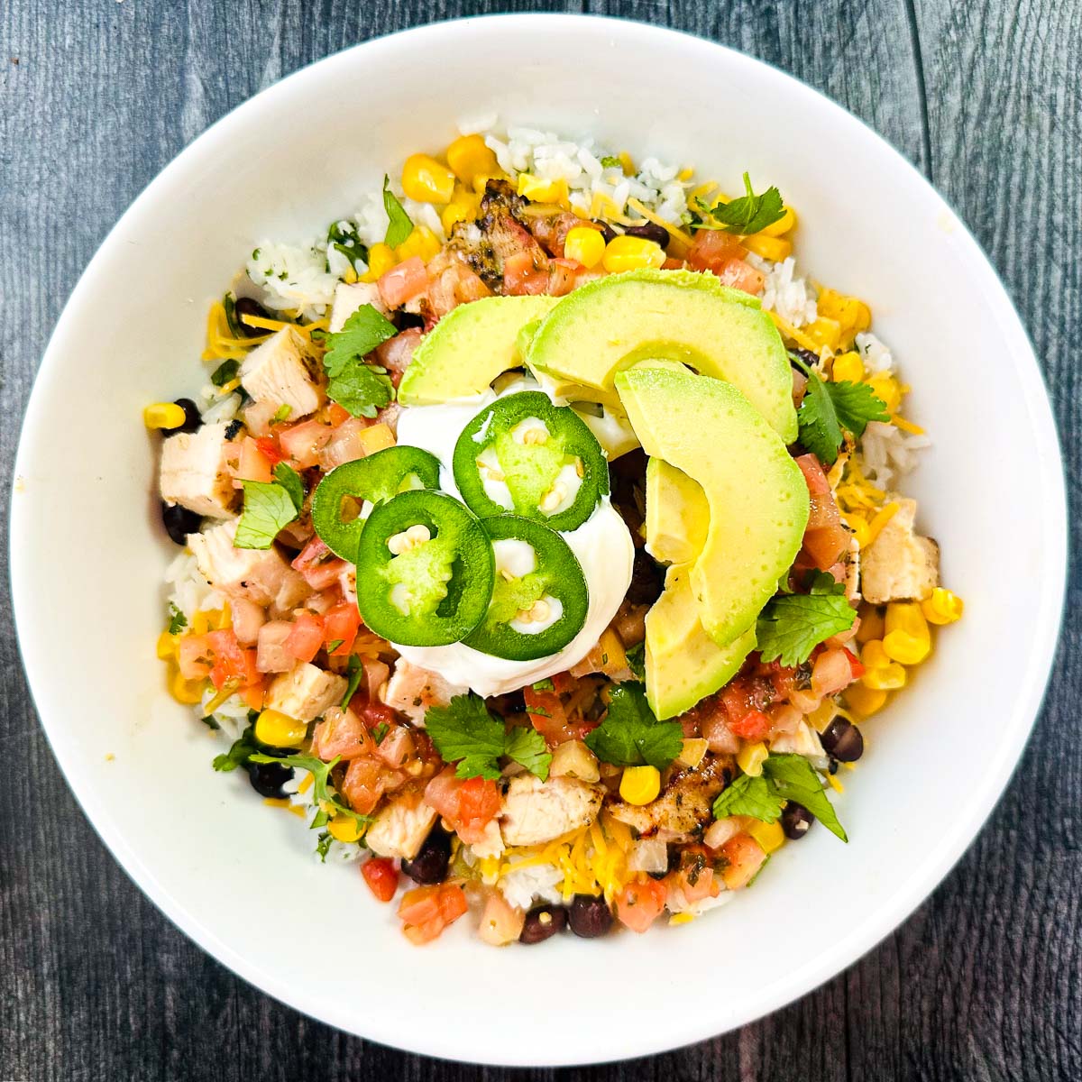 white bowl with Mexican rice bowl and lots of toppings