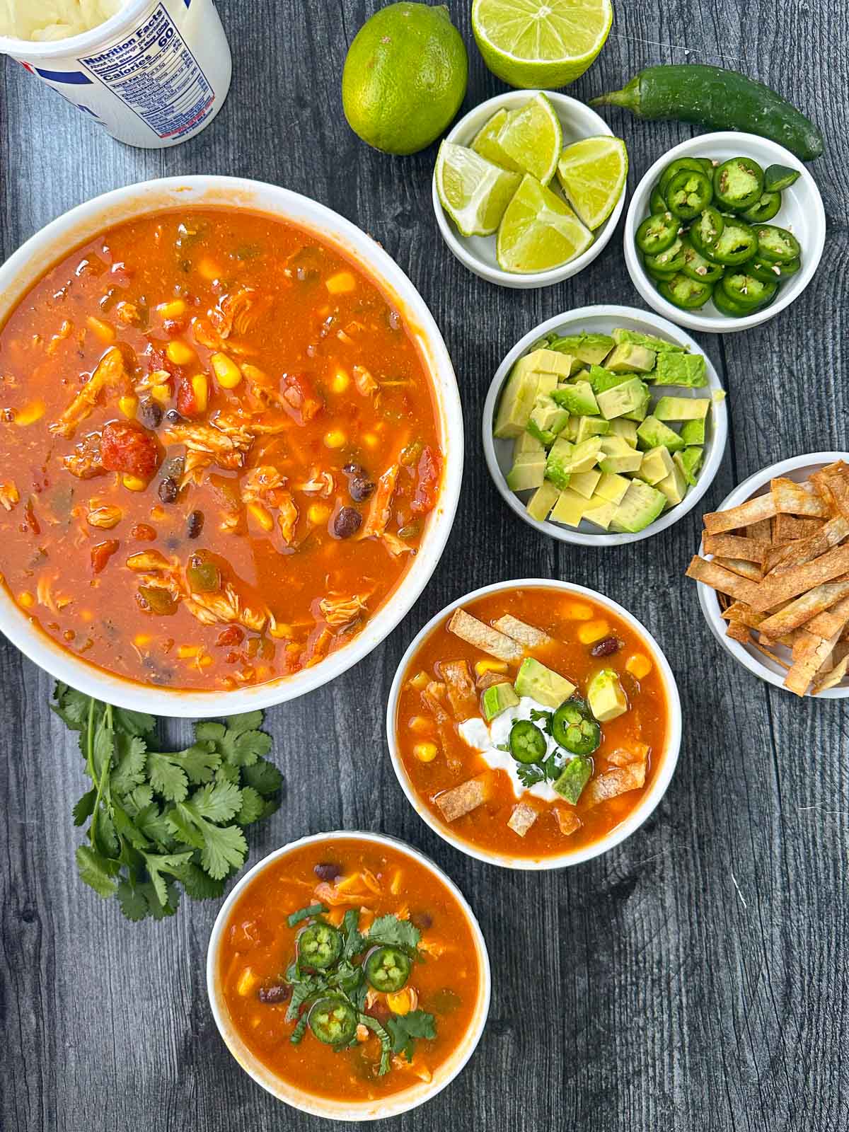 aerial view of bowls of slow cooker chicken tortilla soup and toppings