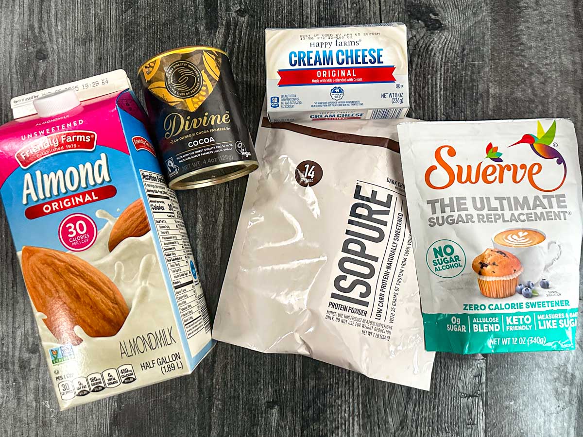 recipe ingredients - almond milk, chocolate protein powder, cream cheese, cocoa powder and swerve sweetener
