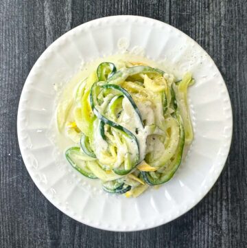 aerial view of white plate with lemon ricotta zucchini noodles