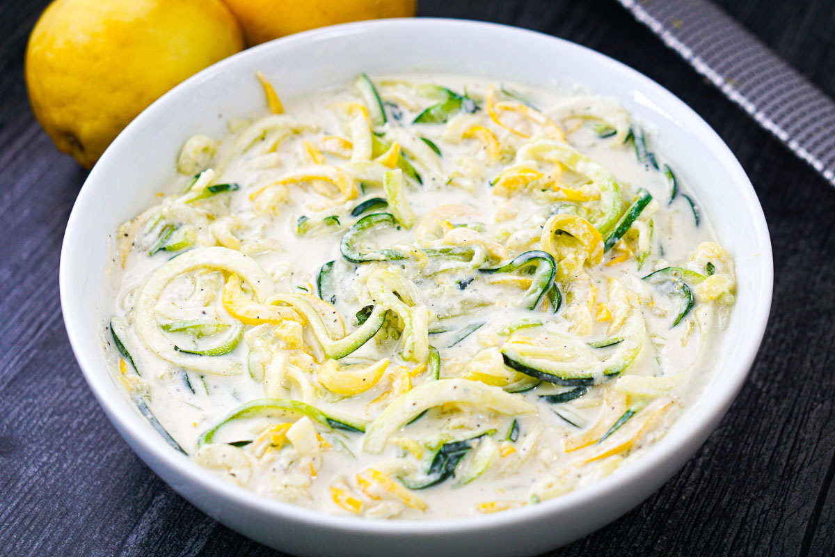 white bowl with zucchini noodles with keto creamy ricotta sauce