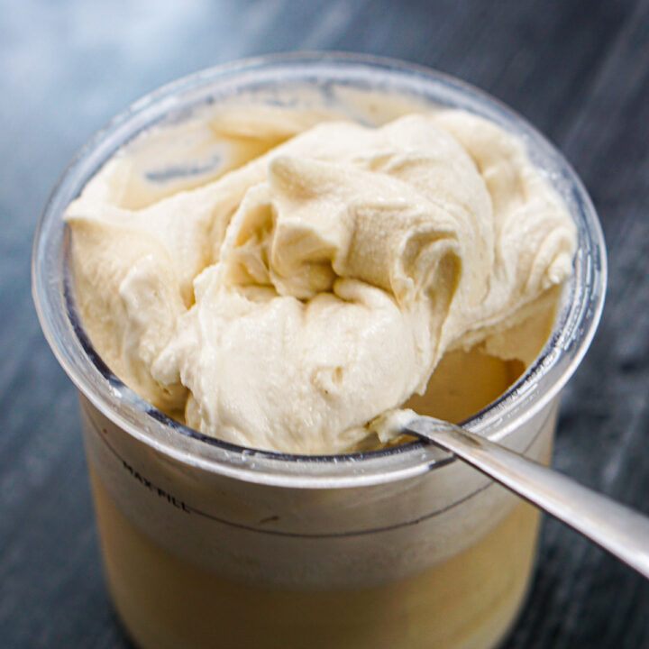 closeup of pint container with a spoonful of maple ice cream