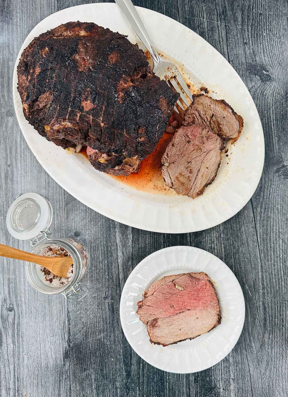 aerial view of a platter and plate with air fryer roast lamb