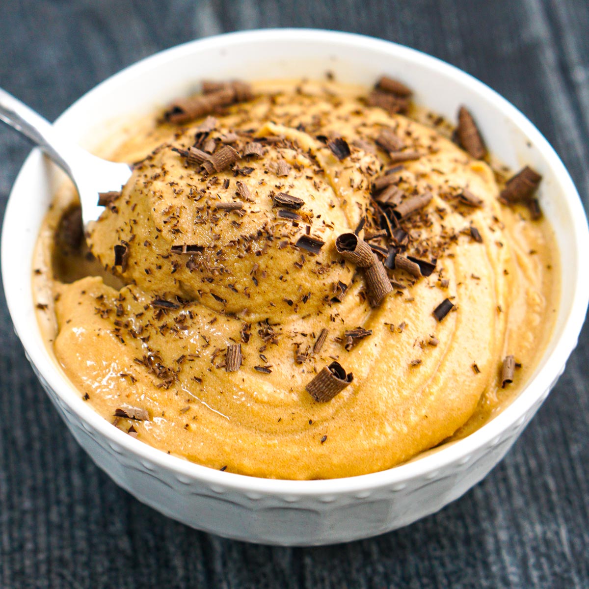 white bowl with Ninja Creami coffee ice cream with chocolate shavings on top
