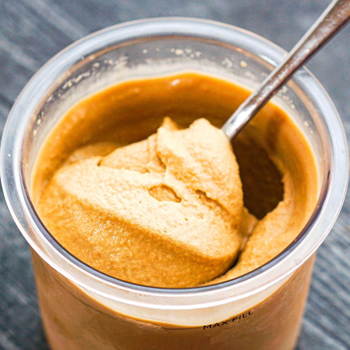 closeup of a pint container or Ninja Creami coffee ice cream with a spoon in it