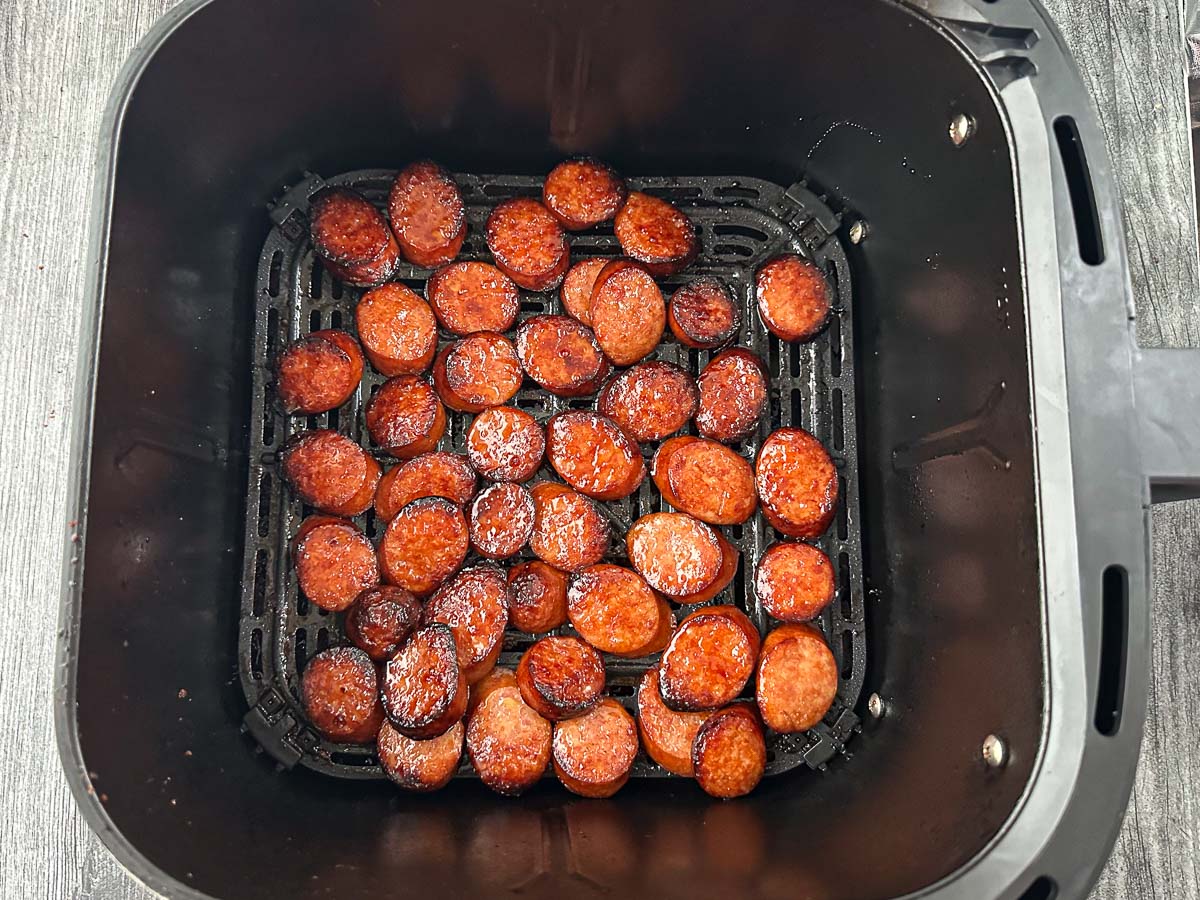 air fryer basket with finished spicy kielbasa bites