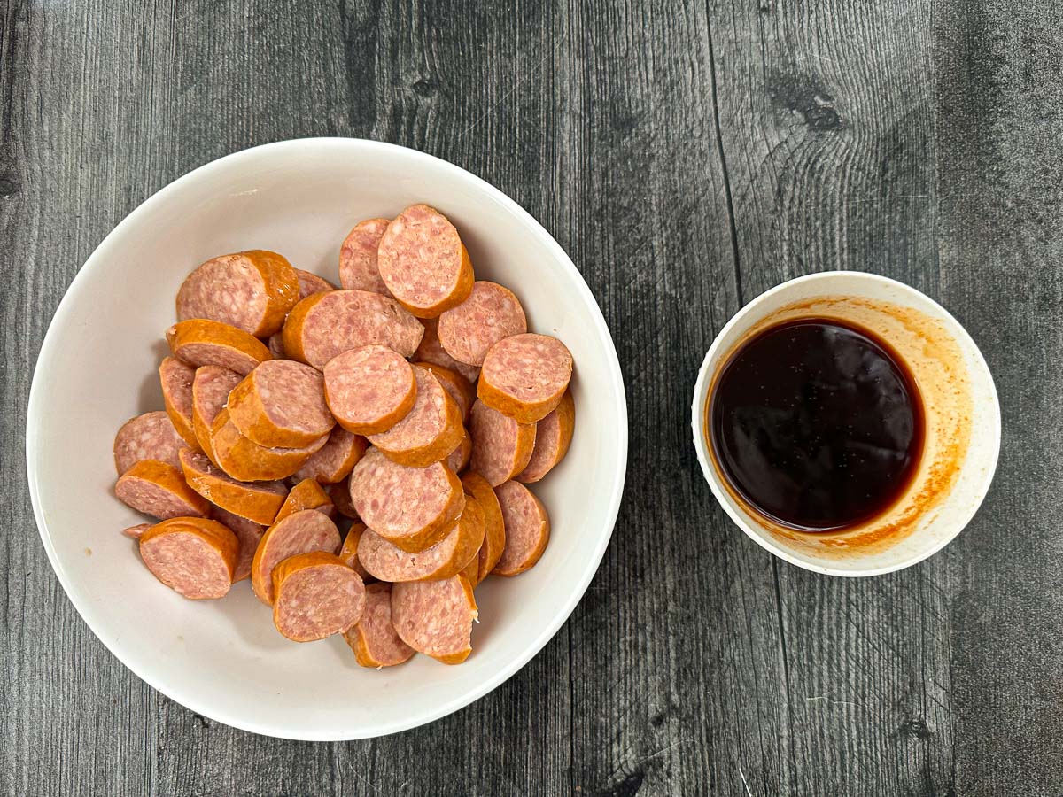 polish sausage cut into slices in a bowl with sweet spicy sauce