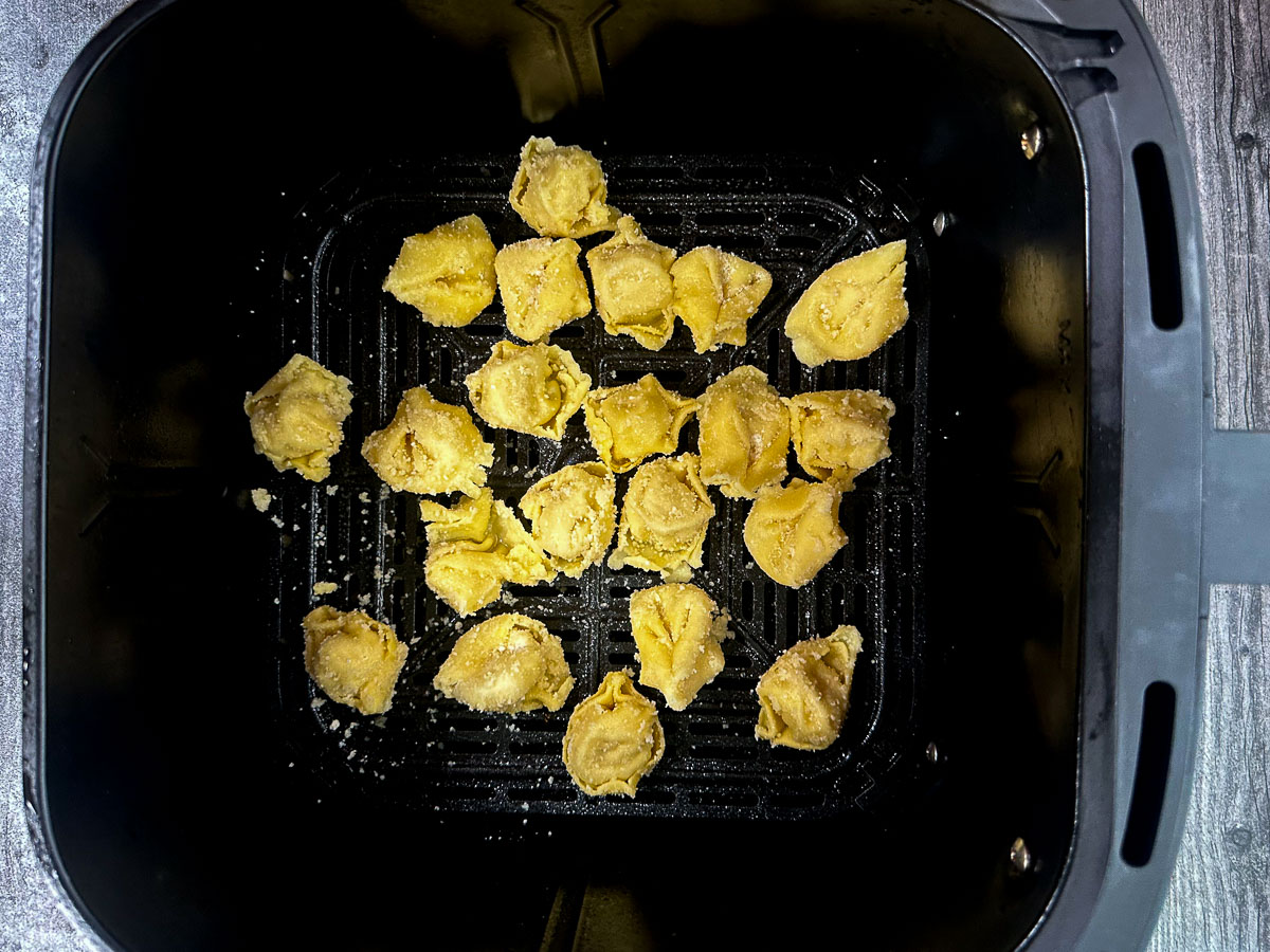 air fryer basket with uncooked tortilla