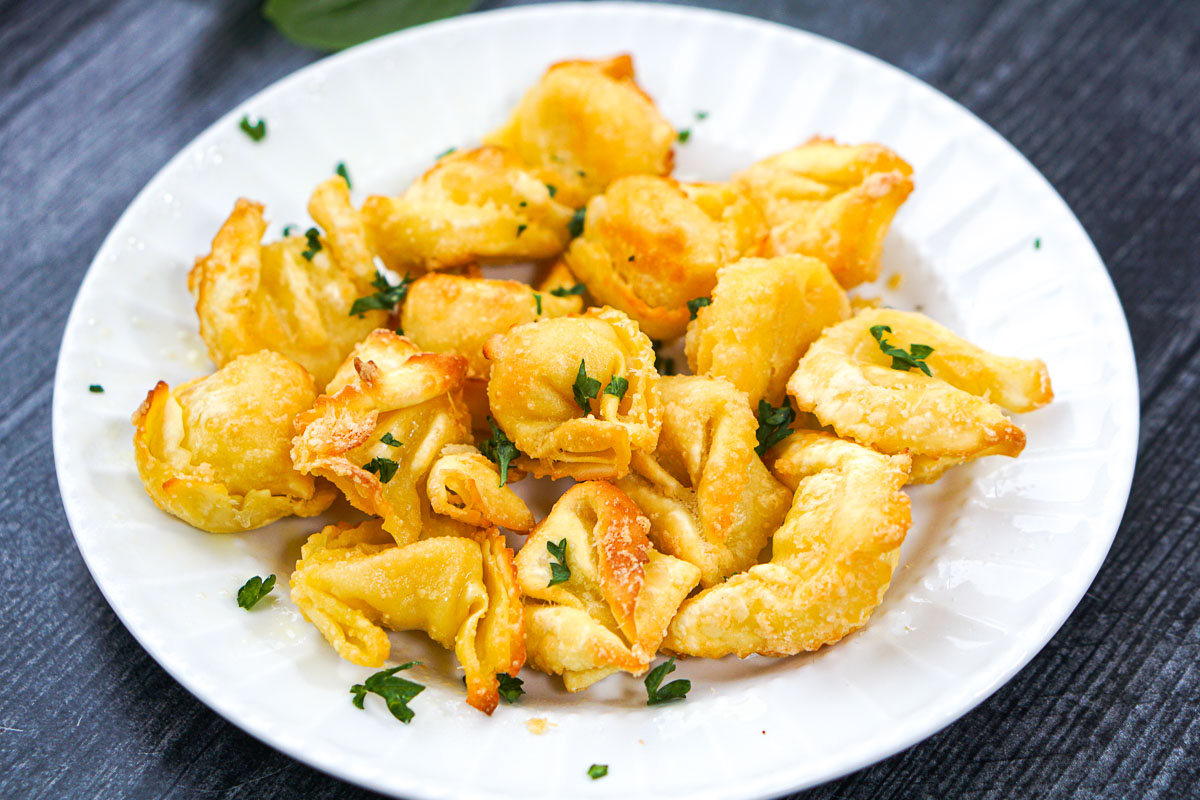 closeup white plate with air fried tortellini appetizer