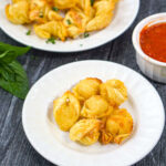 white plates with air fried tortellini and fresh basil with text