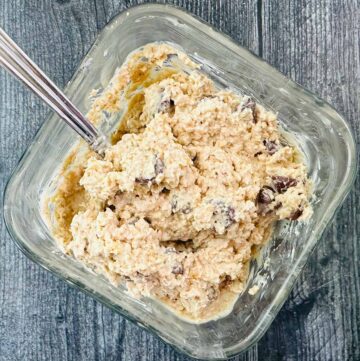 glass container with cookie dough oatmeal and a spoon