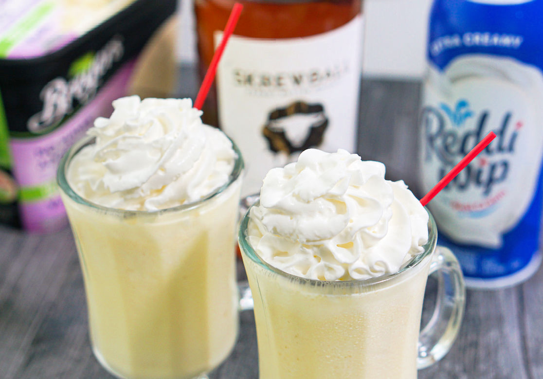 aerial view of a peanut butter whiskey banana milkshake and red straw