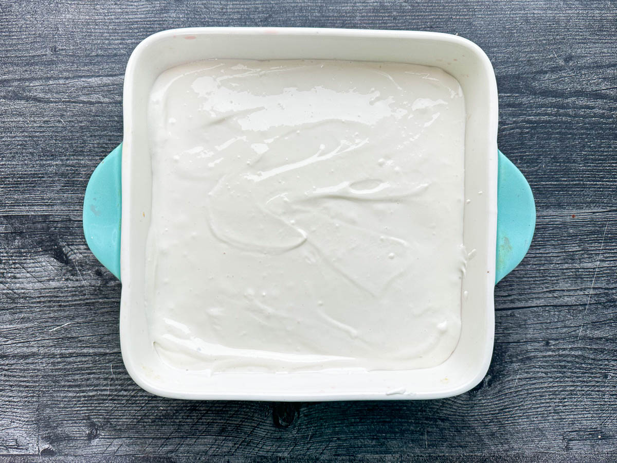 baking dish with whipped cottage cheese on top of jello