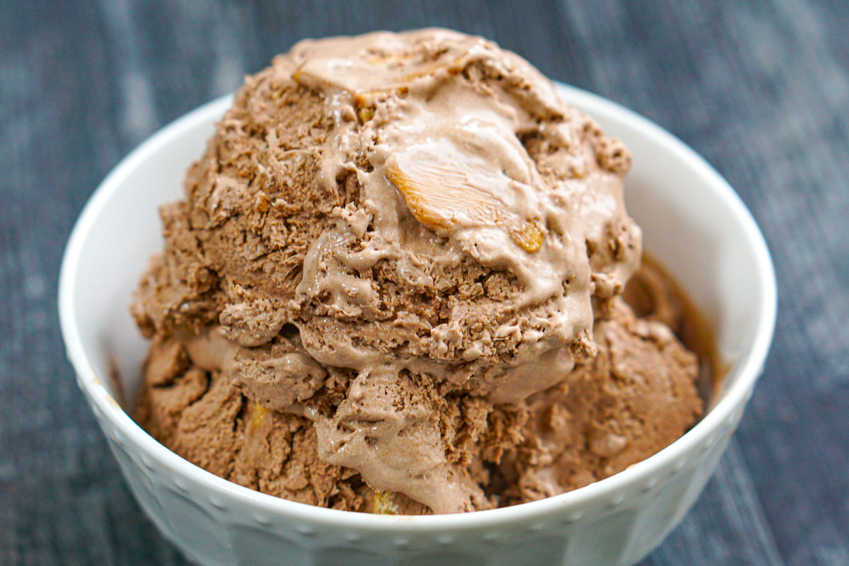 White bowl with serving of keto chocolate peanut butter ice cream.