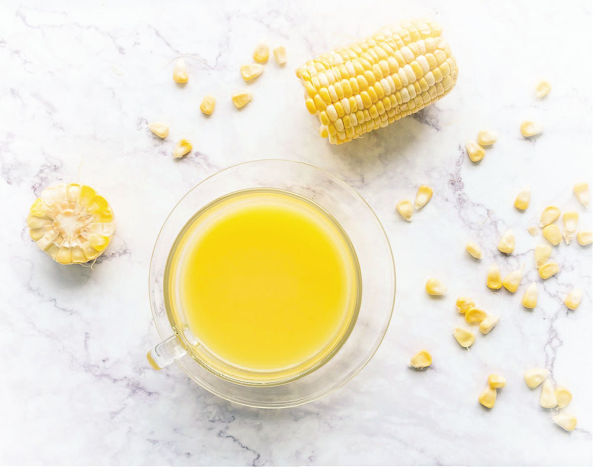 raw corn cob and kernels with melted butter