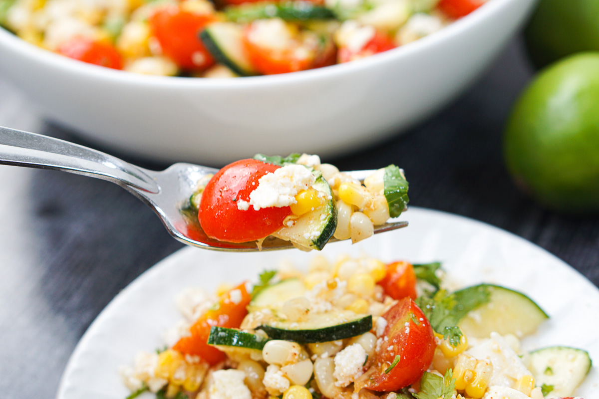 a forkful of zucchini corn salad
