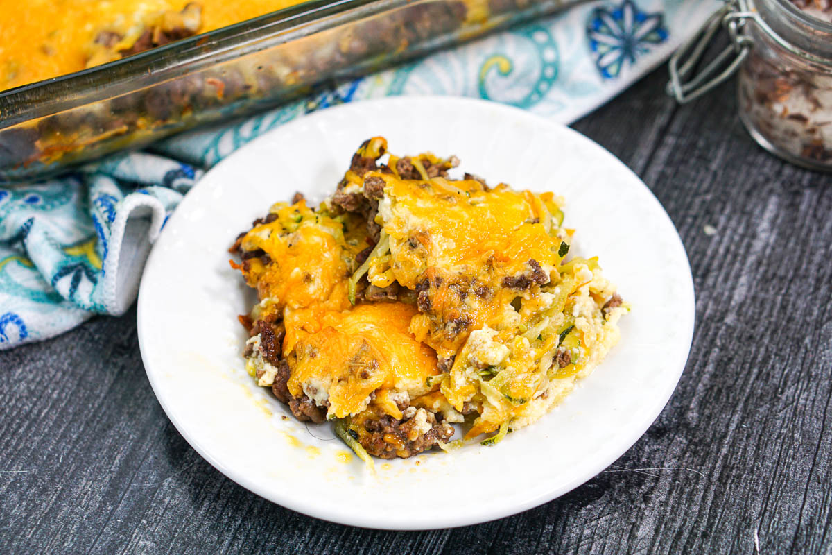 white plate with a serving of keto casserole with squash and meat and cheese