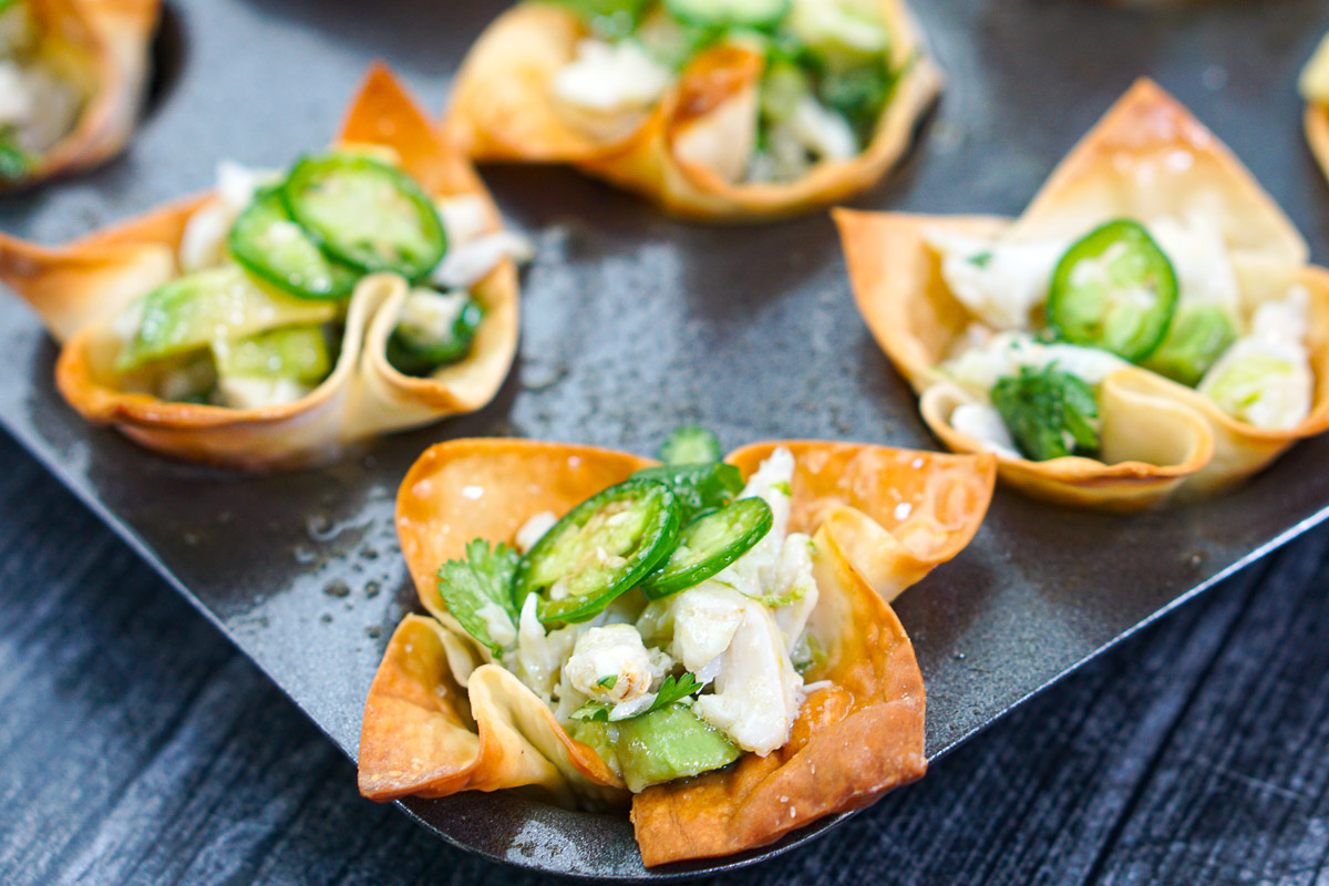 closeup of wonton cups in muffin tin with crab appetizer