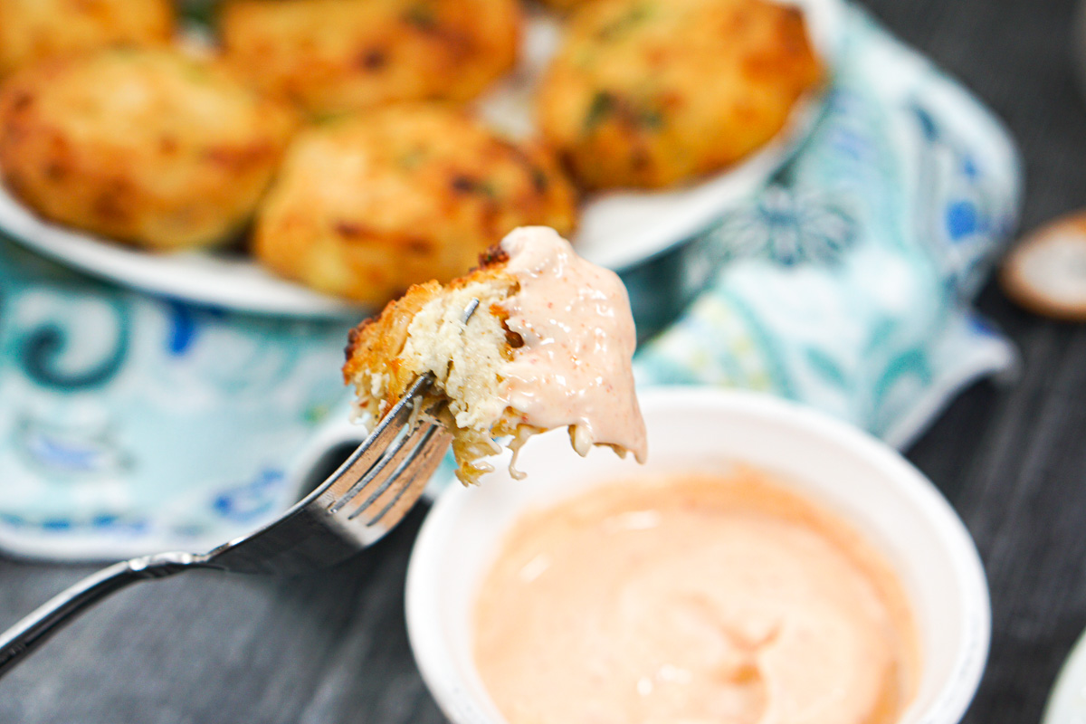 a fork with a chicken patty dipped in aioli