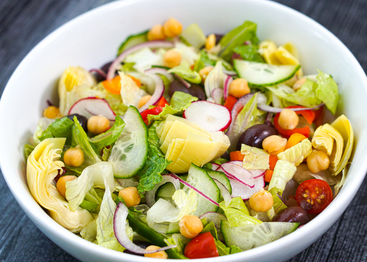 white salad bowl with Greek salad