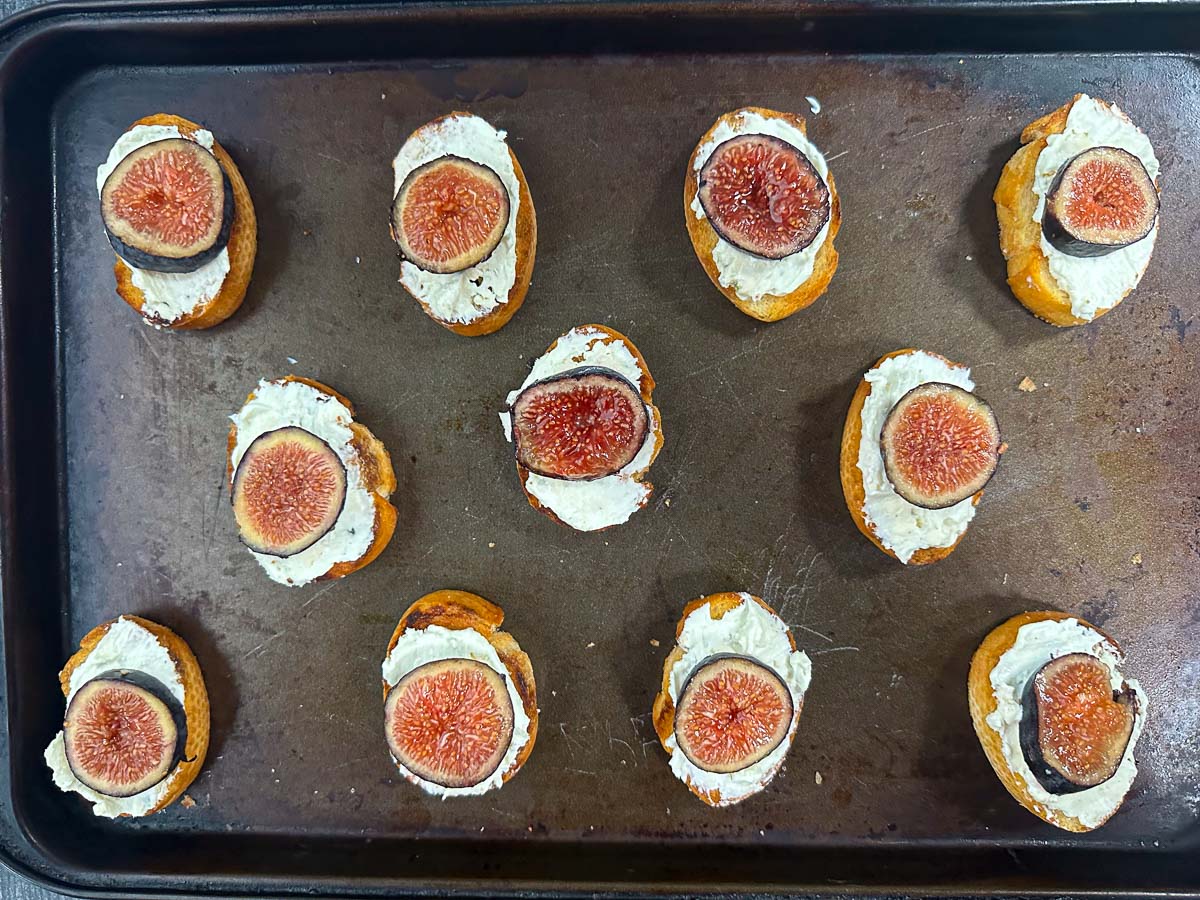baking sheet with crostini appetizer ready to bake