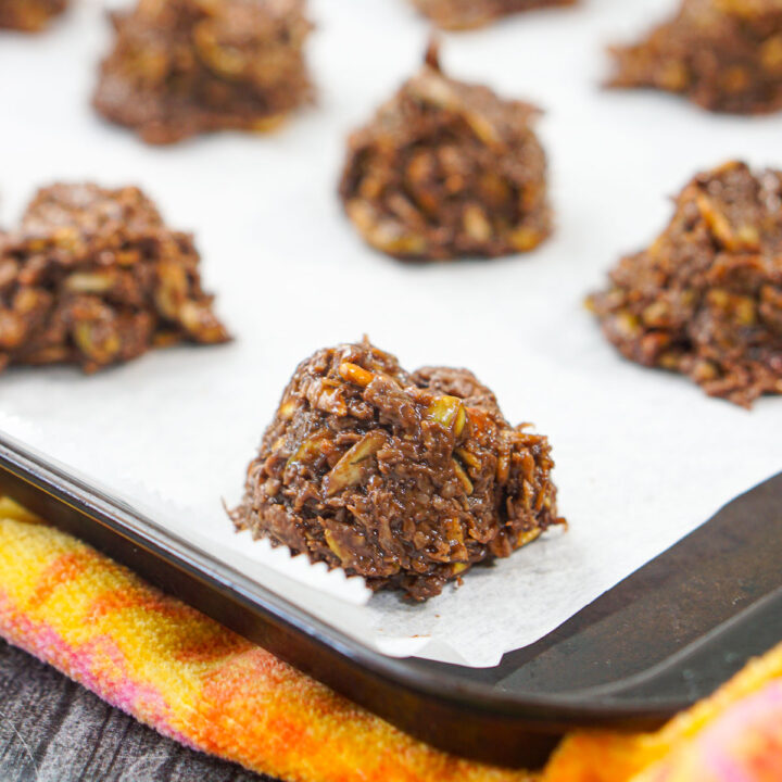 cookie sheet covered in parchment paper and keto no bake cookies on it