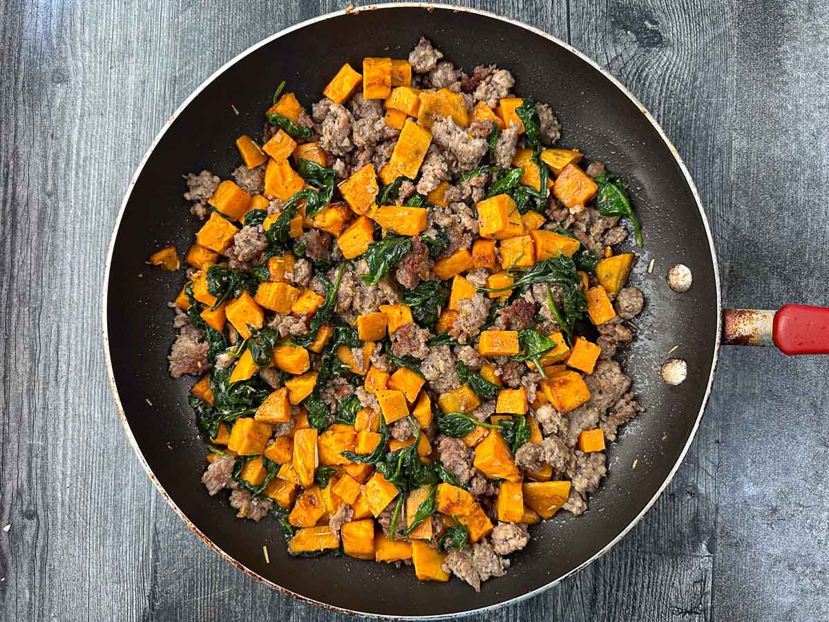 pan with sweet potatoes, sausage and spinach