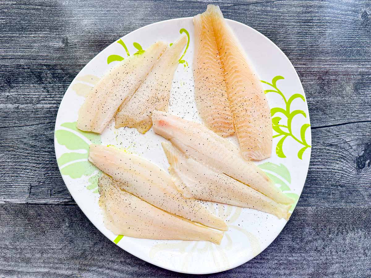 white plate with thawed fish fillets