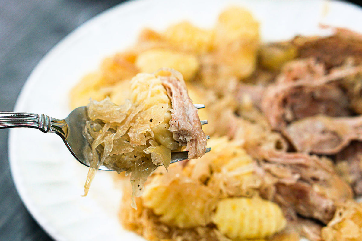 a forkful of pork, sauerkraut and gnocchi
