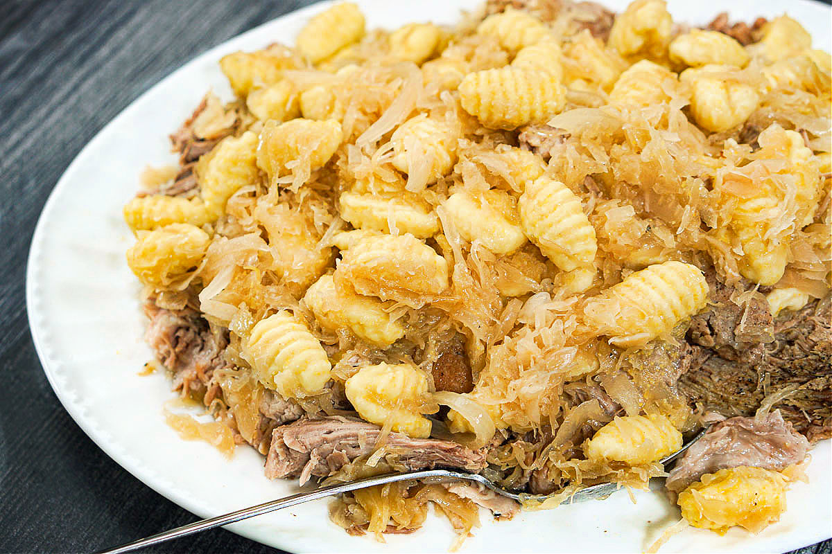 closeup of a platter of slow cooker pork sauerkraut and gnocchi
