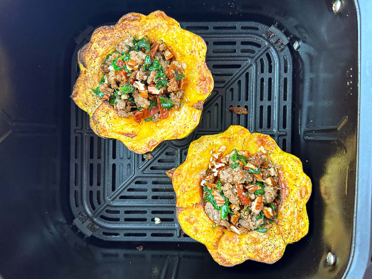 air fryer basket with sausage stuffed acorn squash