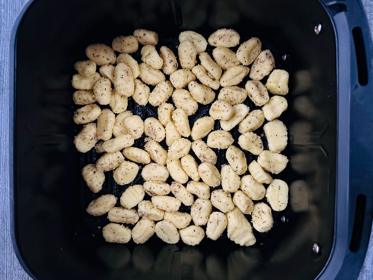 air fryer basket with uncooked gnocchi