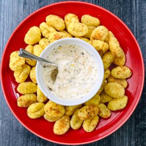 red plate with air fryer gnocchi appetizer with dipping sauce