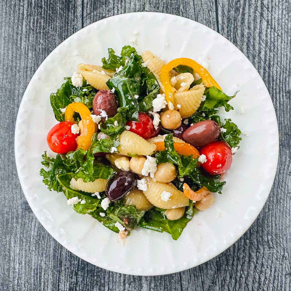 white plate with kale pasta salad