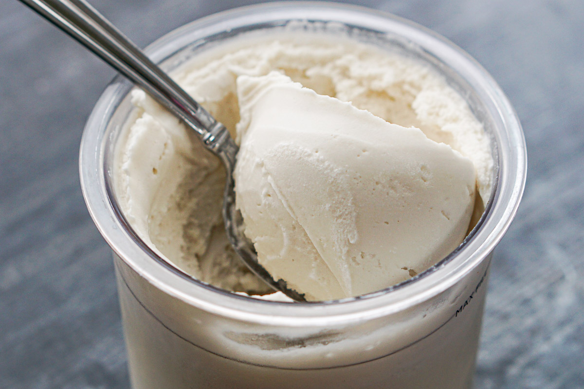closeup of pint container with a spoonful of just churned Ninja Cream peppermint ice cream