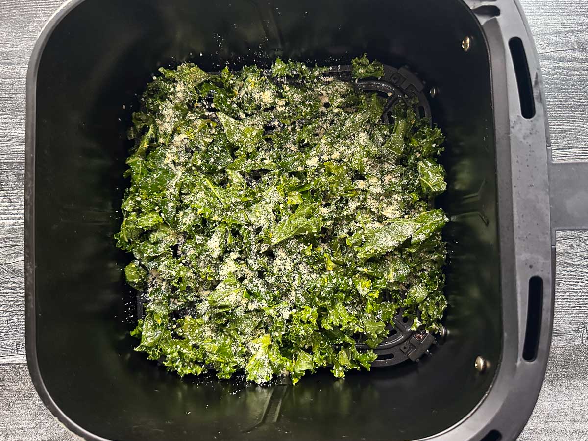 air fryer basket with raw parmesan kale