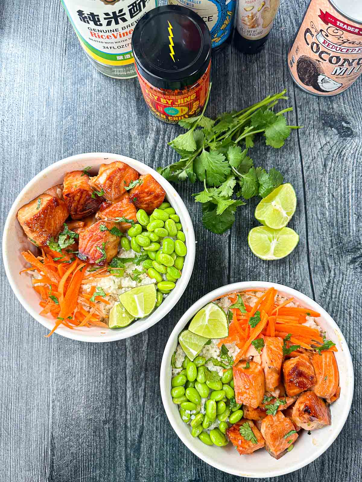 aerial view of Asian salmon buddha bowls with fresh cilantro and limes