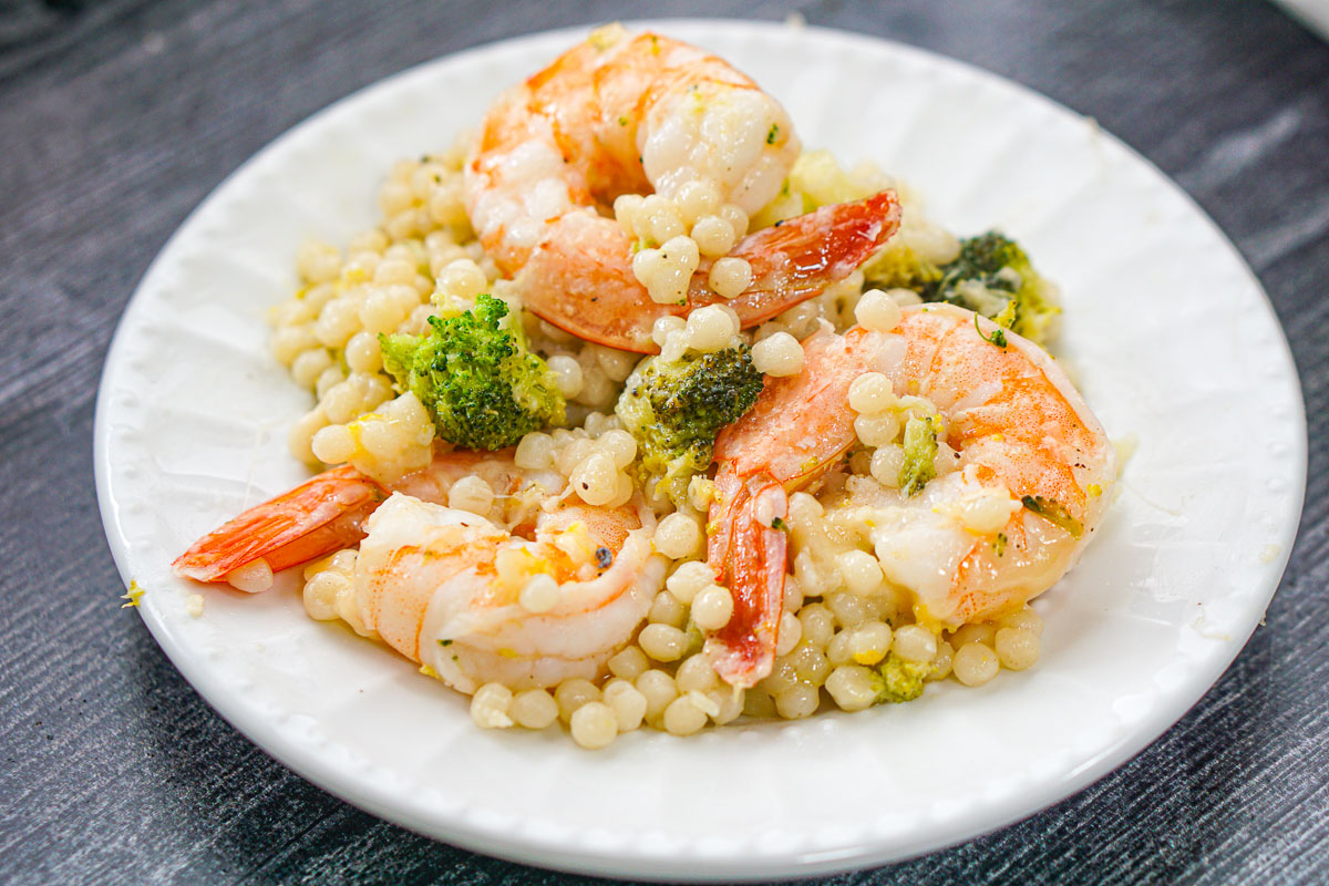 closeup of a couscous and shrimp with lemon and broccoli