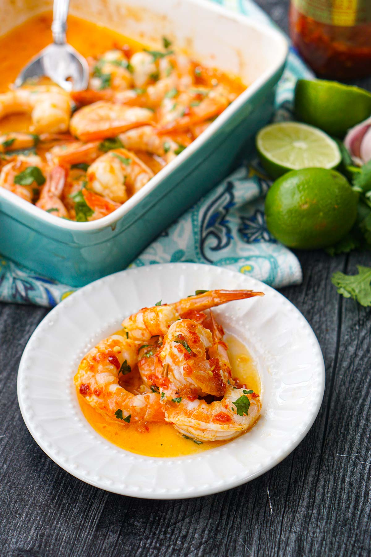 blue baking dish and white plate with keto Yucatan shrimp with fresh limes and cilantro