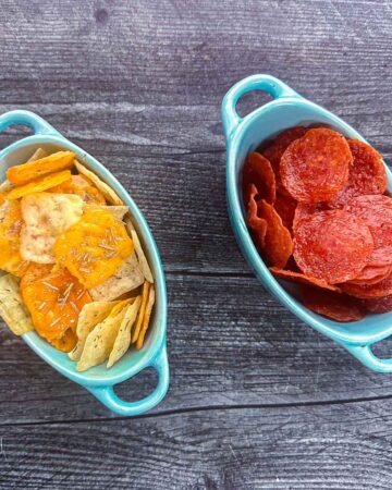 2 blue dishes with keto cheese chips and pepperoni chips