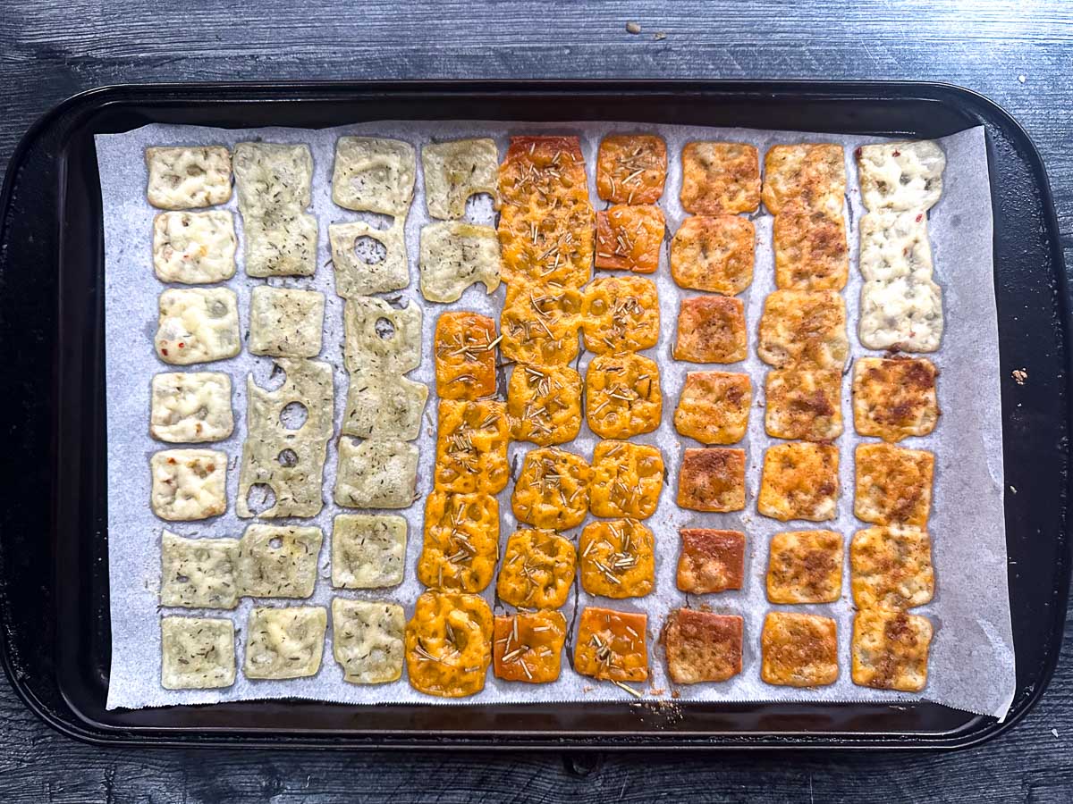 baking sheet with assorted cheese chips in different flavors fresh from the oven