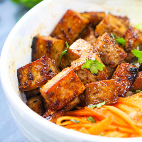 closeup of a white bowl with crispy tofu pieces