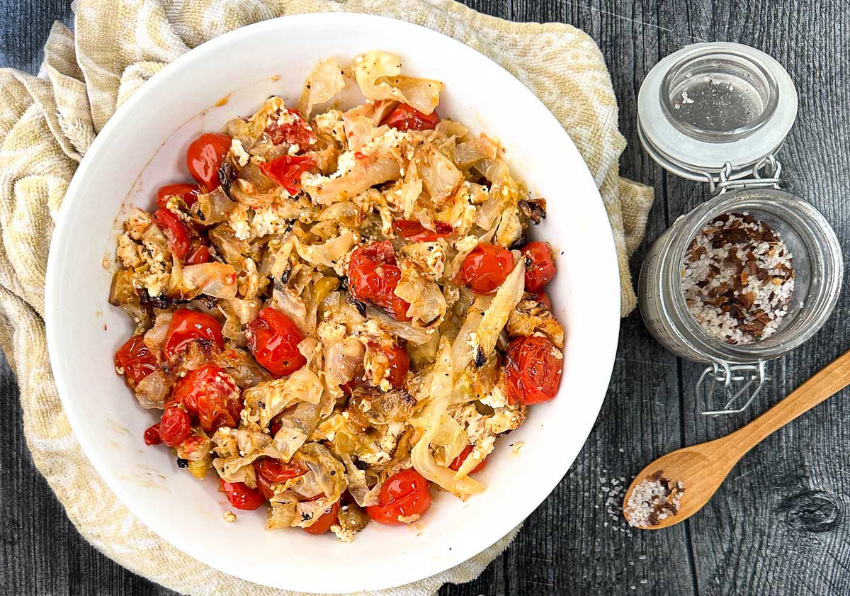 white bowl with roasted cabbage and tomatoes dish